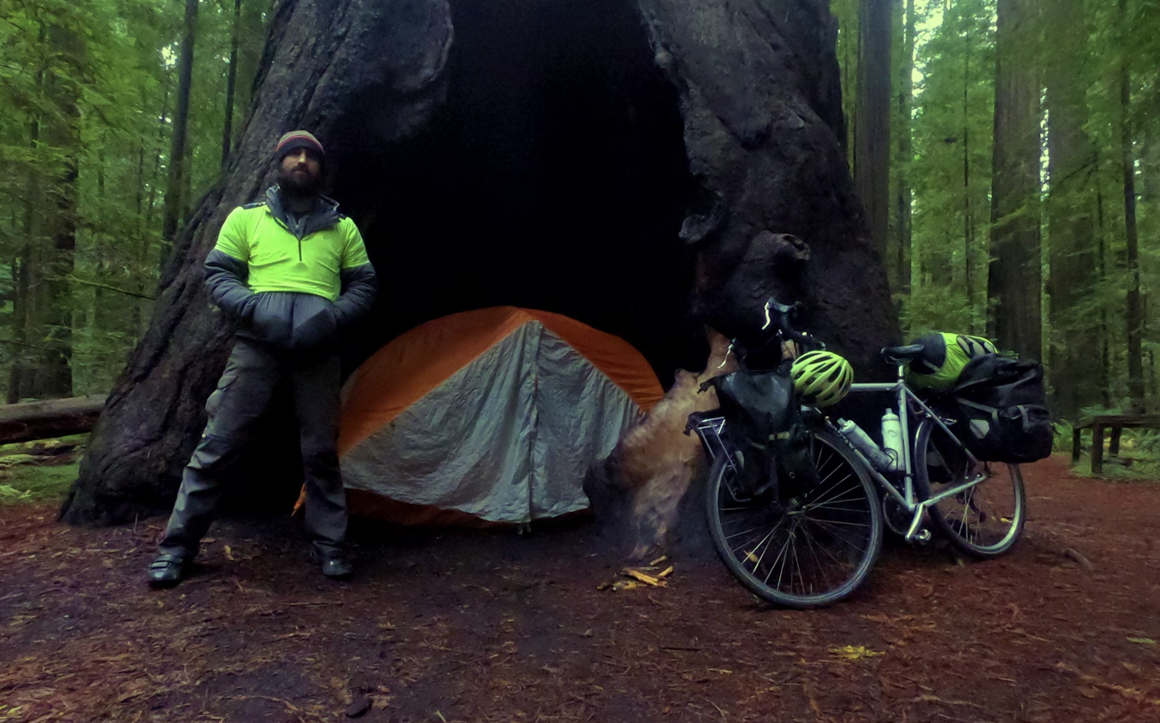 a man in a tent under a tree